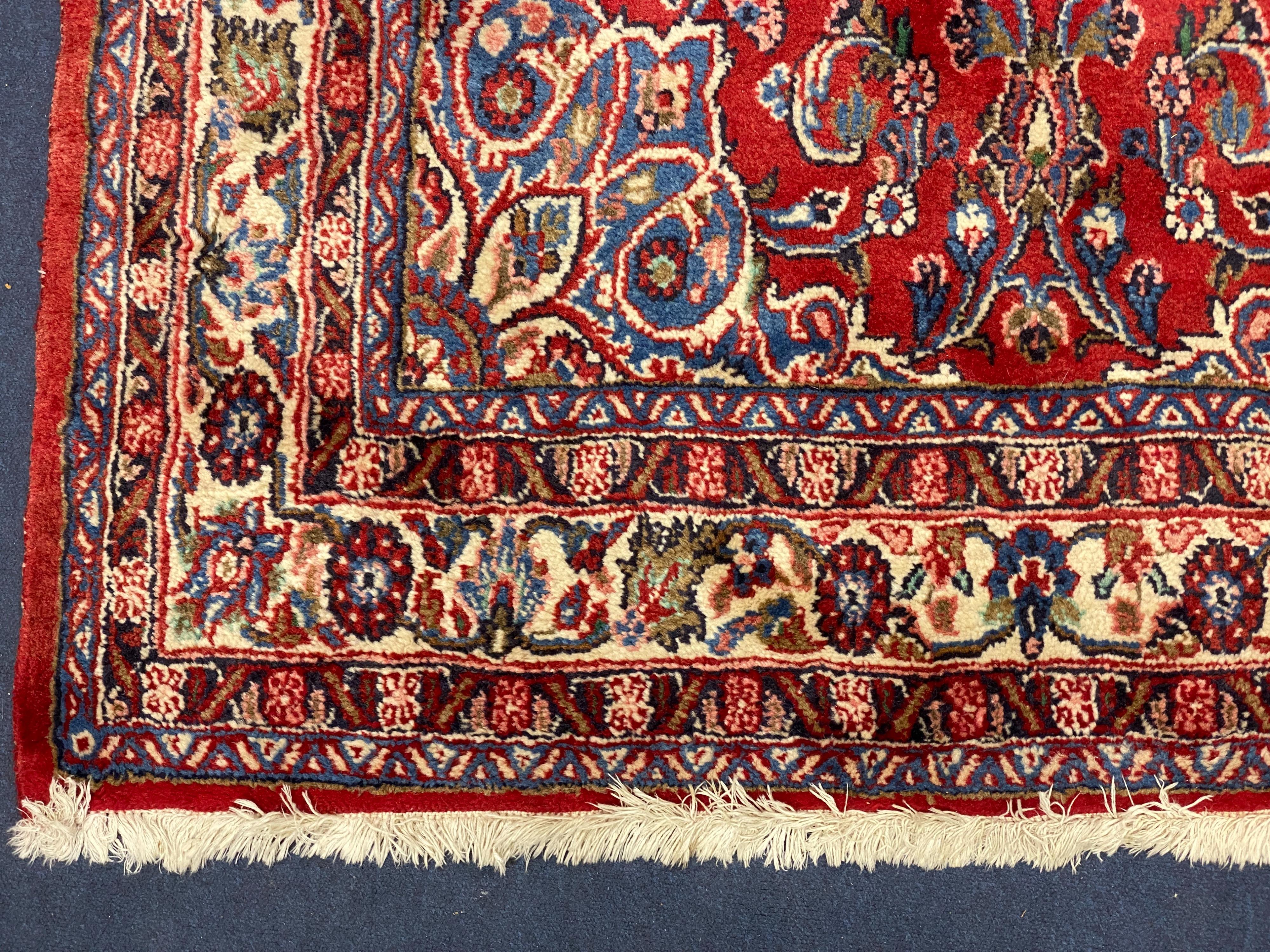 A Northwest Persian red ground rug, 240 cm x 136 cm
